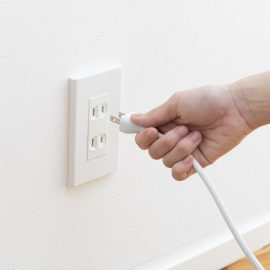 Hand Plugging in Cord in Outlet