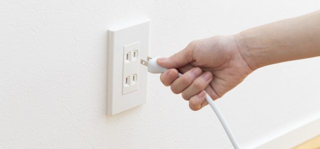 Hand Plugging in Cord in Outlet