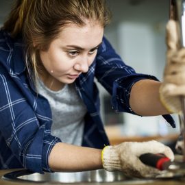 Woman Fixes Sink